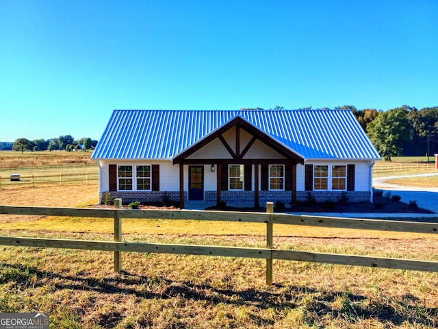 view of front of house featuring a front yard and a rural view