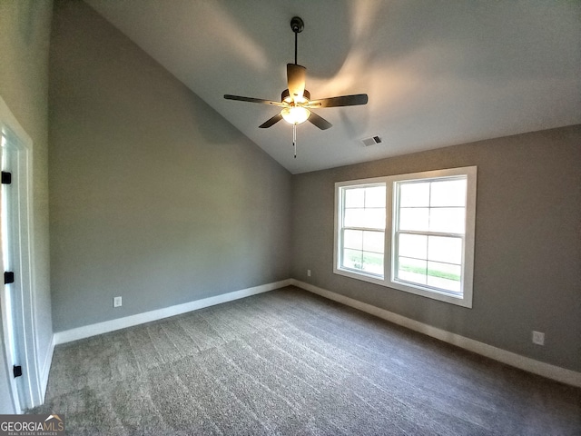 spare room with ceiling fan, vaulted ceiling, and carpet floors