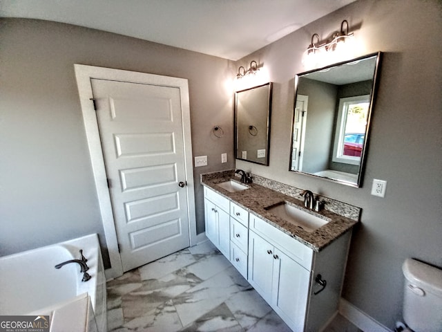 bathroom featuring vanity, a tub, and toilet