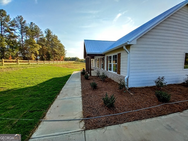 view of property exterior with a lawn