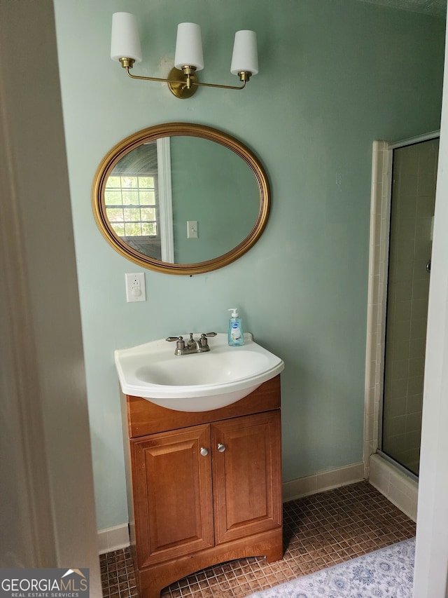 bathroom with vanity, a shower with door, and tile patterned flooring