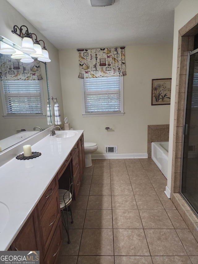 full bathroom featuring tile patterned floors, toilet, independent shower and bath, vanity, and a textured ceiling