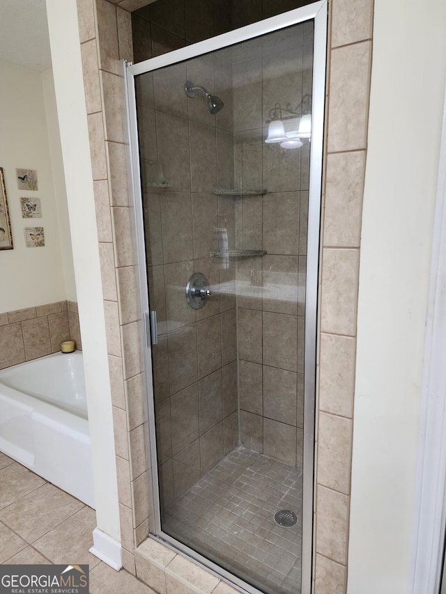 bathroom with tile patterned floors and plus walk in shower