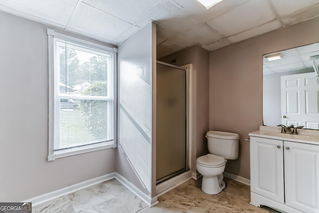 bathroom with walk in shower, a healthy amount of sunlight, and a drop ceiling