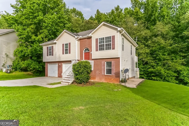 raised ranch with a garage and a front lawn