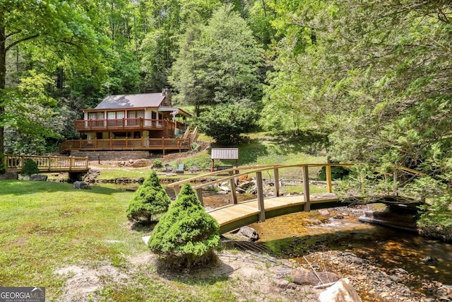 view of yard featuring a deck with water view