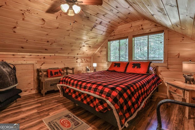 bedroom with wooden walls, lofted ceiling, hardwood / wood-style floors, and wooden ceiling