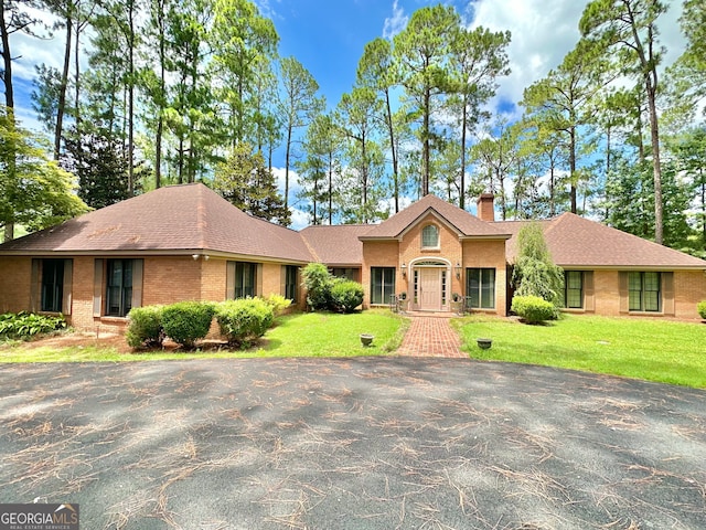 ranch-style home with a front lawn