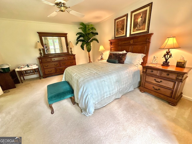 carpeted bedroom with ornamental molding and ceiling fan