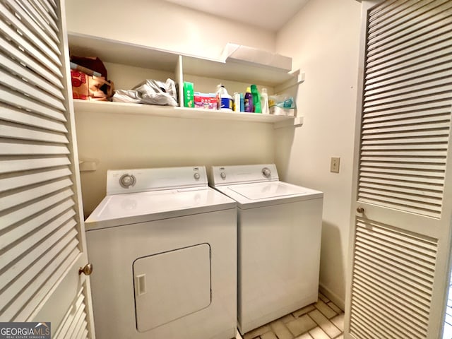 washroom with washing machine and clothes dryer and tile patterned flooring