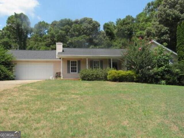 single story home featuring a front yard and a garage