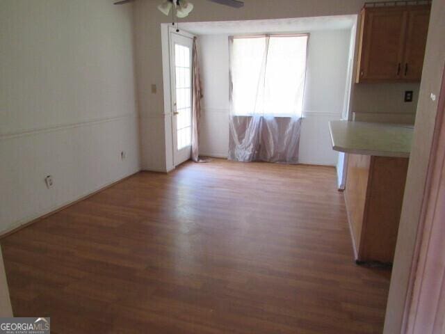 unfurnished dining area with ceiling fan and light hardwood / wood-style floors