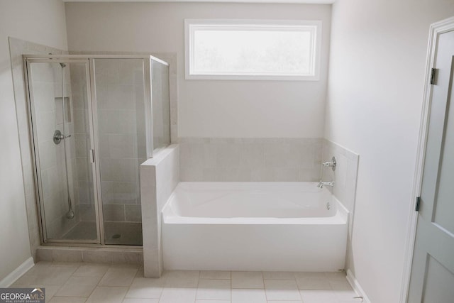 bathroom with tile patterned floors and separate shower and tub