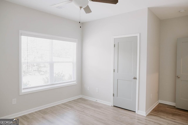 empty room with light hardwood / wood-style flooring and ceiling fan