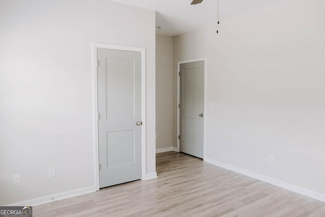 unfurnished room with ceiling fan and light hardwood / wood-style floors