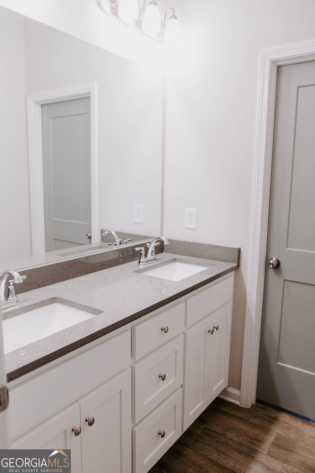 bathroom with vanity and wood-type flooring