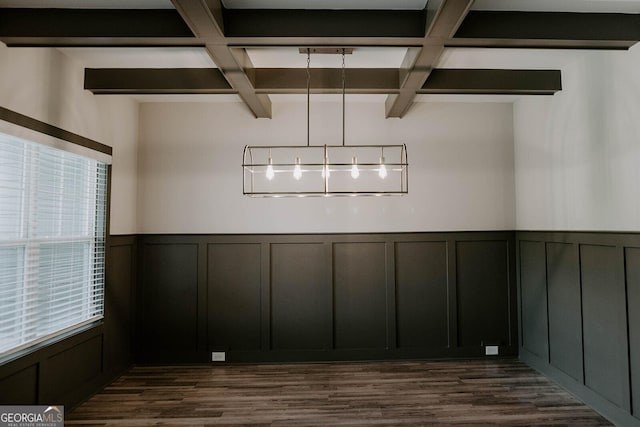 unfurnished dining area with coffered ceiling, beam ceiling, and dark wood-type flooring