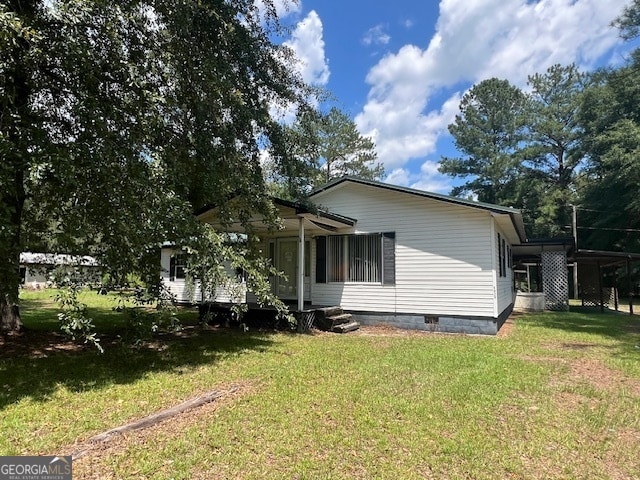 view of side of property with a lawn