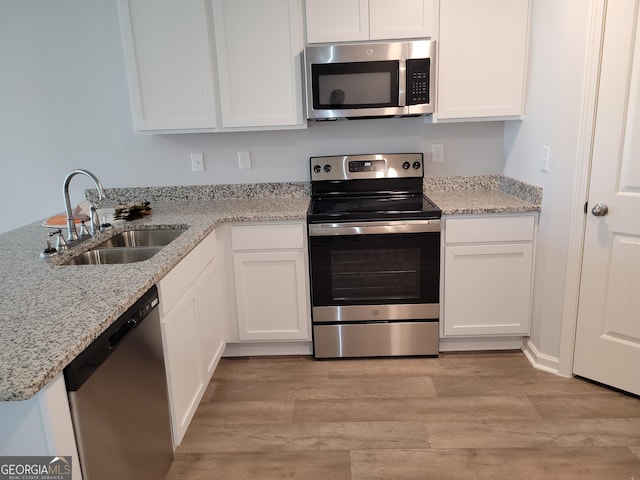 726 Windstream Dr Unit A10, Lagrange, GA 30241 - kitchen with appliances with stainless steel finishes, light hardwood / wood-style flooring, white cabinets, and sink