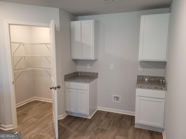 726 Windstream Dr Unit A10, Lagrange, GA 30241 - kitchen featuring dark stone counters, hardwood / wood-style flooring, and white cabinetry