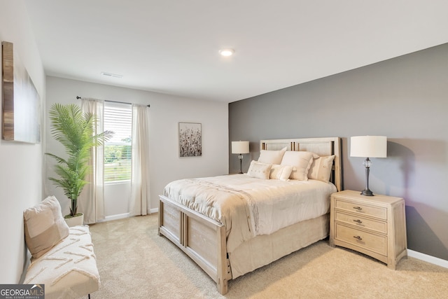 bedroom featuring light colored carpet, visible vents, and baseboards