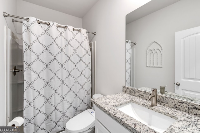 bathroom featuring a shower with curtain, vanity, and toilet