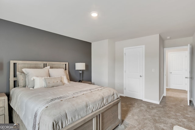 bedroom with baseboards and light colored carpet