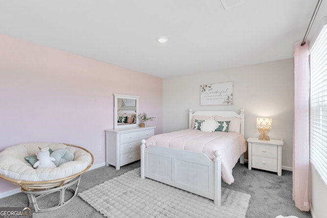 bedroom with light carpet and baseboards