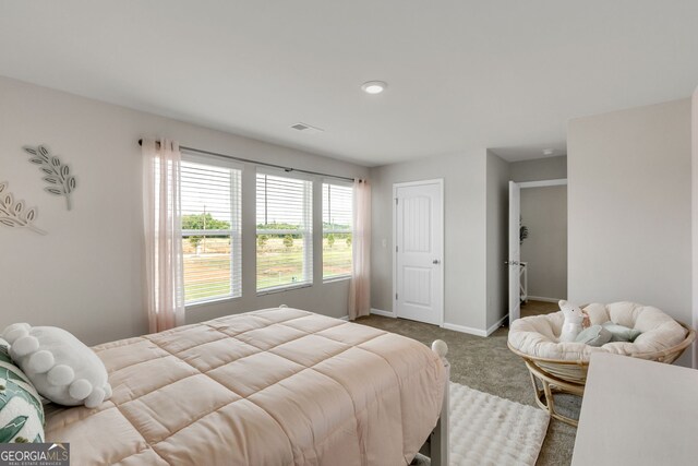 carpeted bedroom featuring baseboards and visible vents