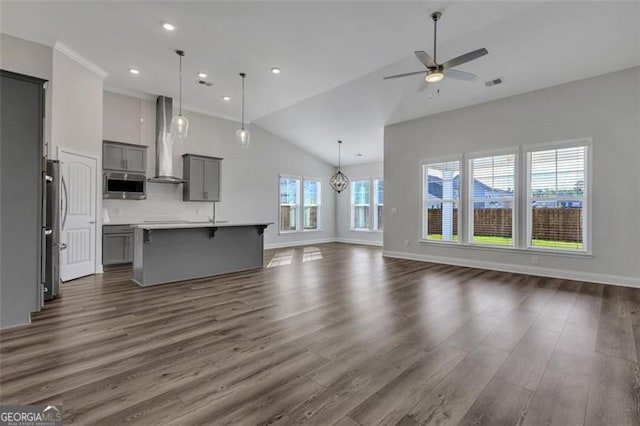 unfurnished living room with ceiling fan, high vaulted ceiling, and dark wood-type flooring