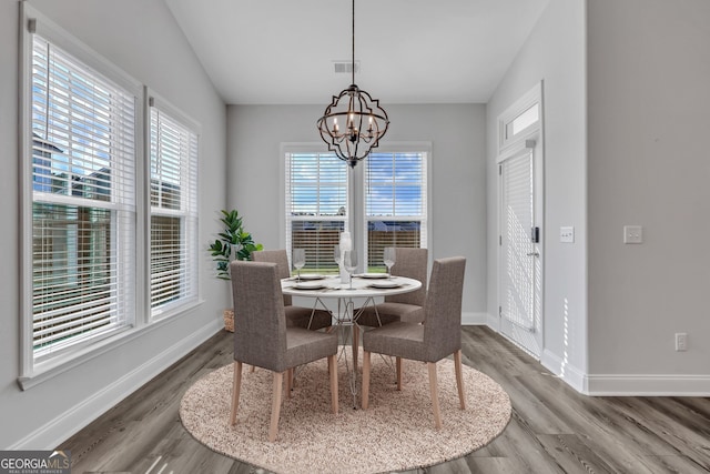 dining space featuring a notable chandelier and wood-type flooring