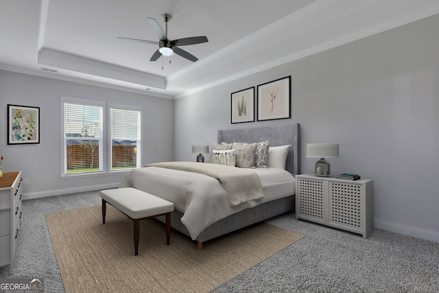 bedroom featuring ceiling fan, light carpet, and a raised ceiling