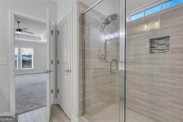 bathroom featuring ceiling fan and walk in shower