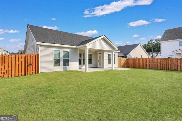 rear view of property with a patio area and a yard