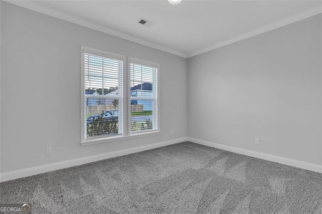 carpeted spare room featuring ornamental molding