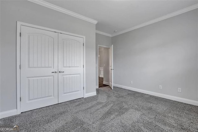 unfurnished bedroom with carpet floors, crown molding, and a closet