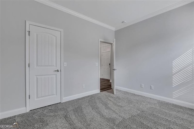 unfurnished bedroom featuring crown molding and carpet flooring