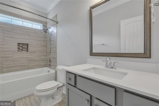 full bathroom featuring toilet, tiled shower / bath, vanity, and ornamental molding