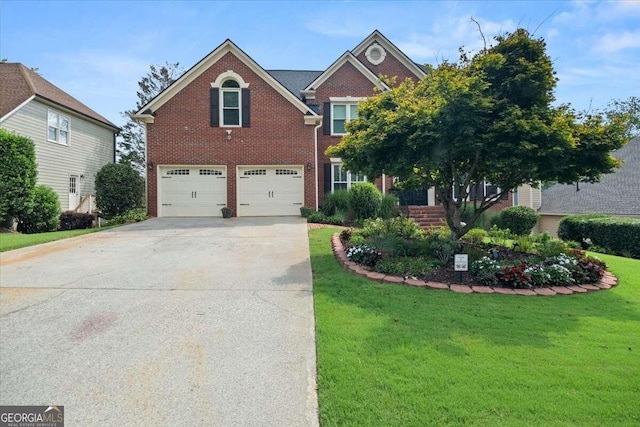 view of front of house featuring a front yard and a garage