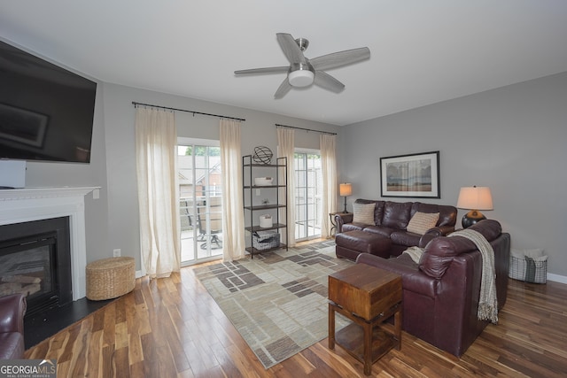 living room with hardwood / wood-style flooring and ceiling fan