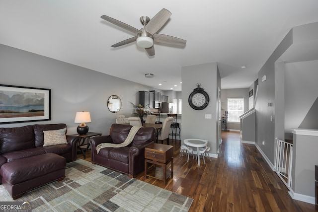 living room with dark wood-type flooring and ceiling fan