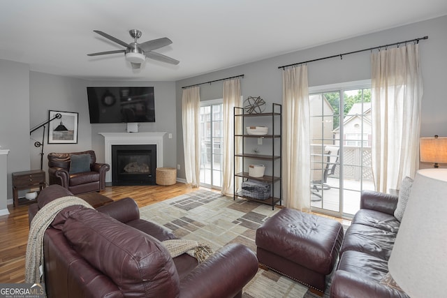 living room featuring light hardwood / wood-style floors and ceiling fan