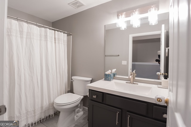 bathroom with vanity, tile patterned flooring, and toilet