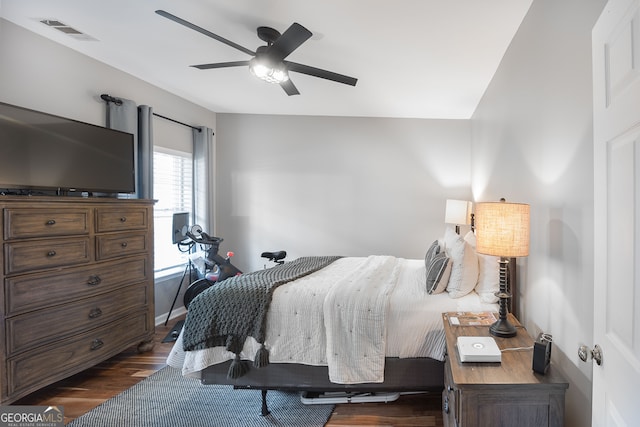 bedroom with ceiling fan and dark hardwood / wood-style flooring