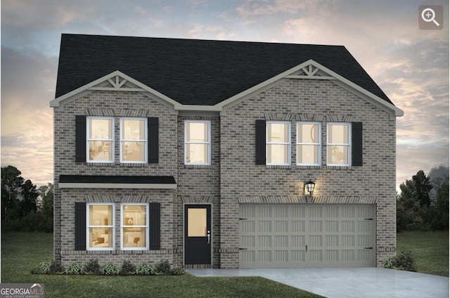 view of front of home with a garage and a yard