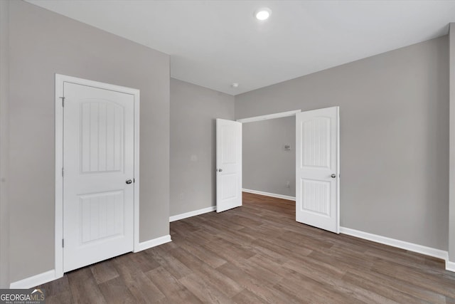 unfurnished bedroom featuring hardwood / wood-style flooring