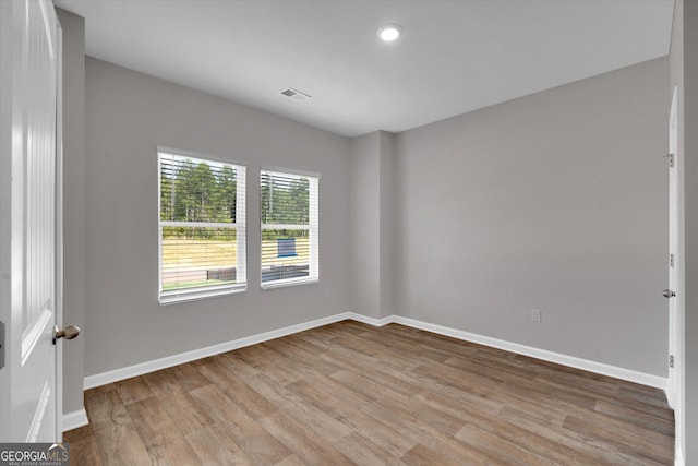 spare room with light hardwood / wood-style floors