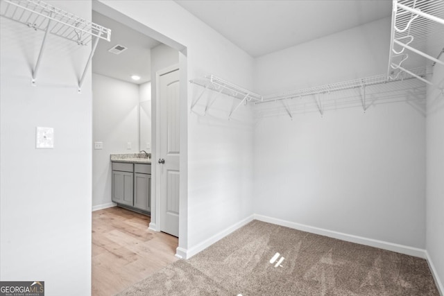 spacious closet featuring light wood-type flooring