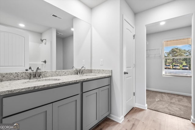 bathroom with vanity, a shower, and wood-type flooring