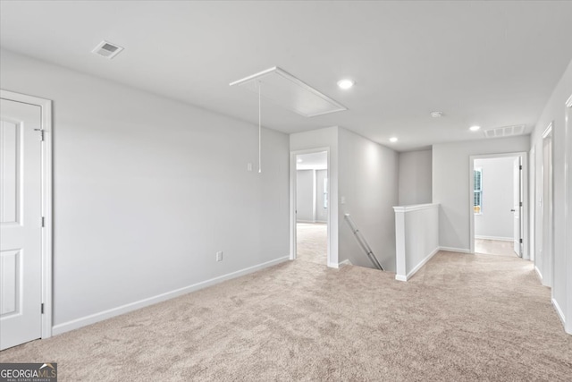 unfurnished room featuring light colored carpet